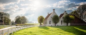 House with clouds and sun in background