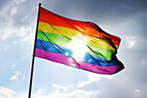 Rainbow Flag against Cloudy Sky