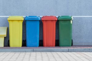 Brightly Colored Trashcans set by Curb. Click to enlarge